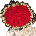 100 red roses arranged in a round bouquet with decorative wrapping in Dhaka – Flower Gift BD