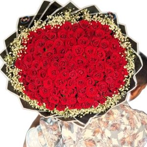 100 red roses arranged in a round bouquet with decorative wrapping in Dhaka – Flower Gift BD