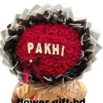 100 red rose bouquet with “PAKHI” lettering and decorative wrapping in Dhaka – Flower Gift BD